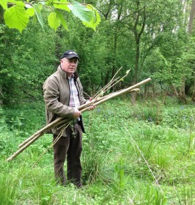 man holding hazel branch