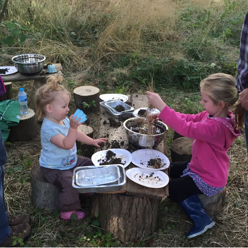 two children playing with mud