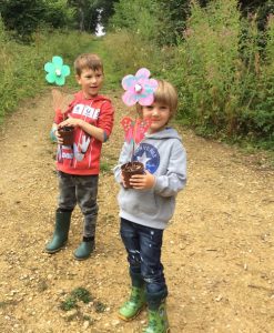 two boys holding butterfly feeders