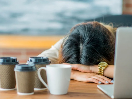 woman with head on desk